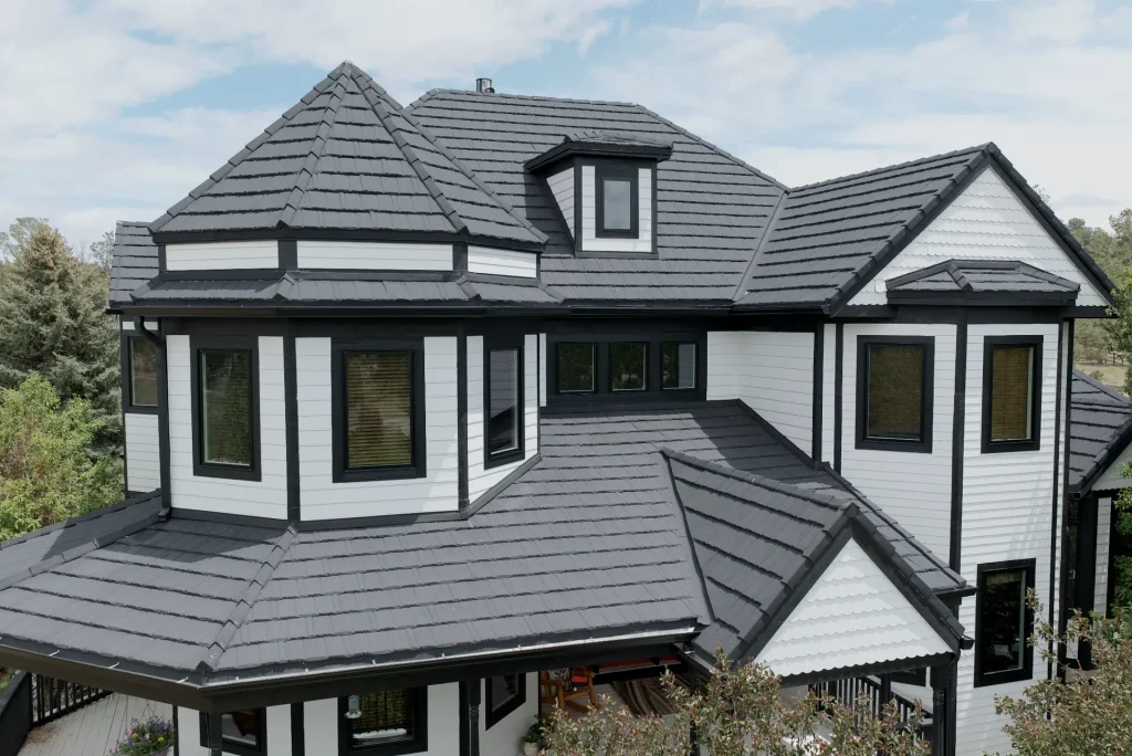 KV Windows whole-home Pella window replacement in Parker, CO: black-frame windows on a white-sided home