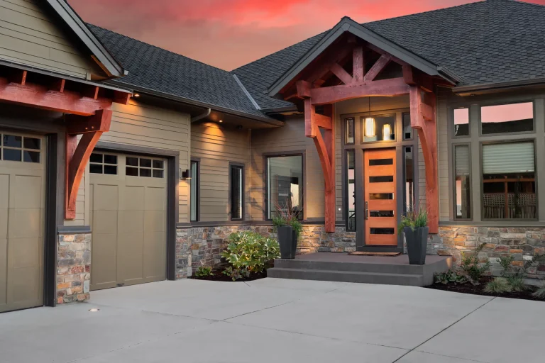 Craftsman-style home exterior with large windows at sunset